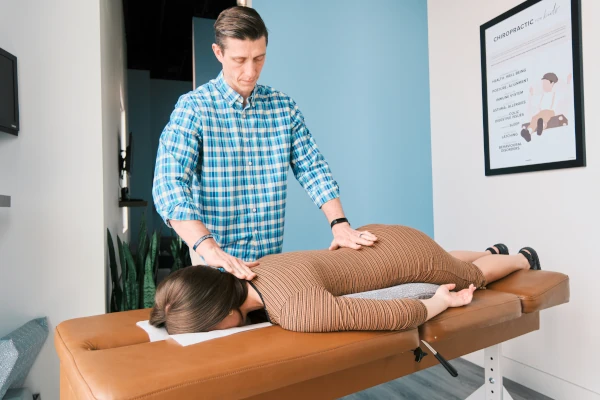Pregnant woman receiving osteopathic treatment of her back